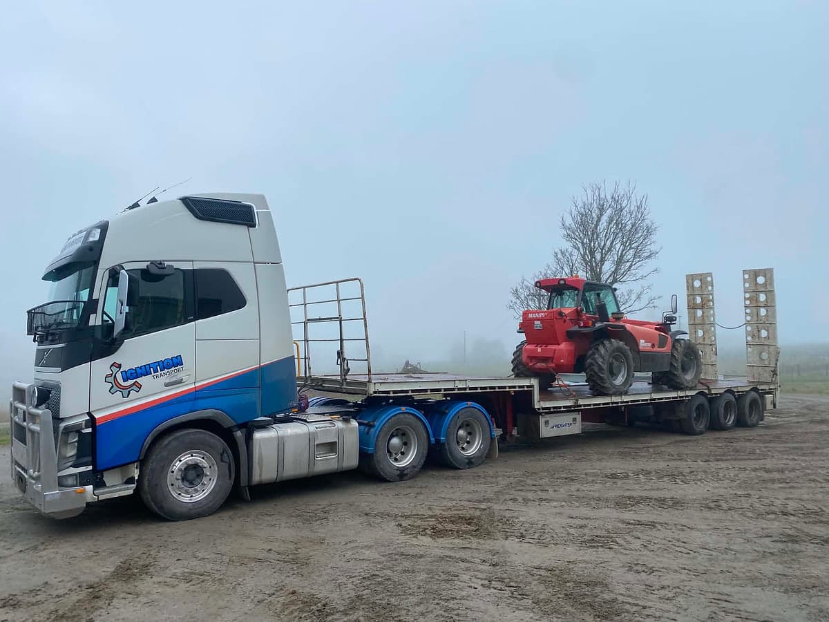 Tractor loaded on the beavertail float