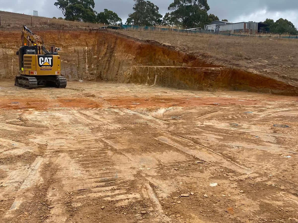 Excavator cutting a bank on a bulk earthworks site